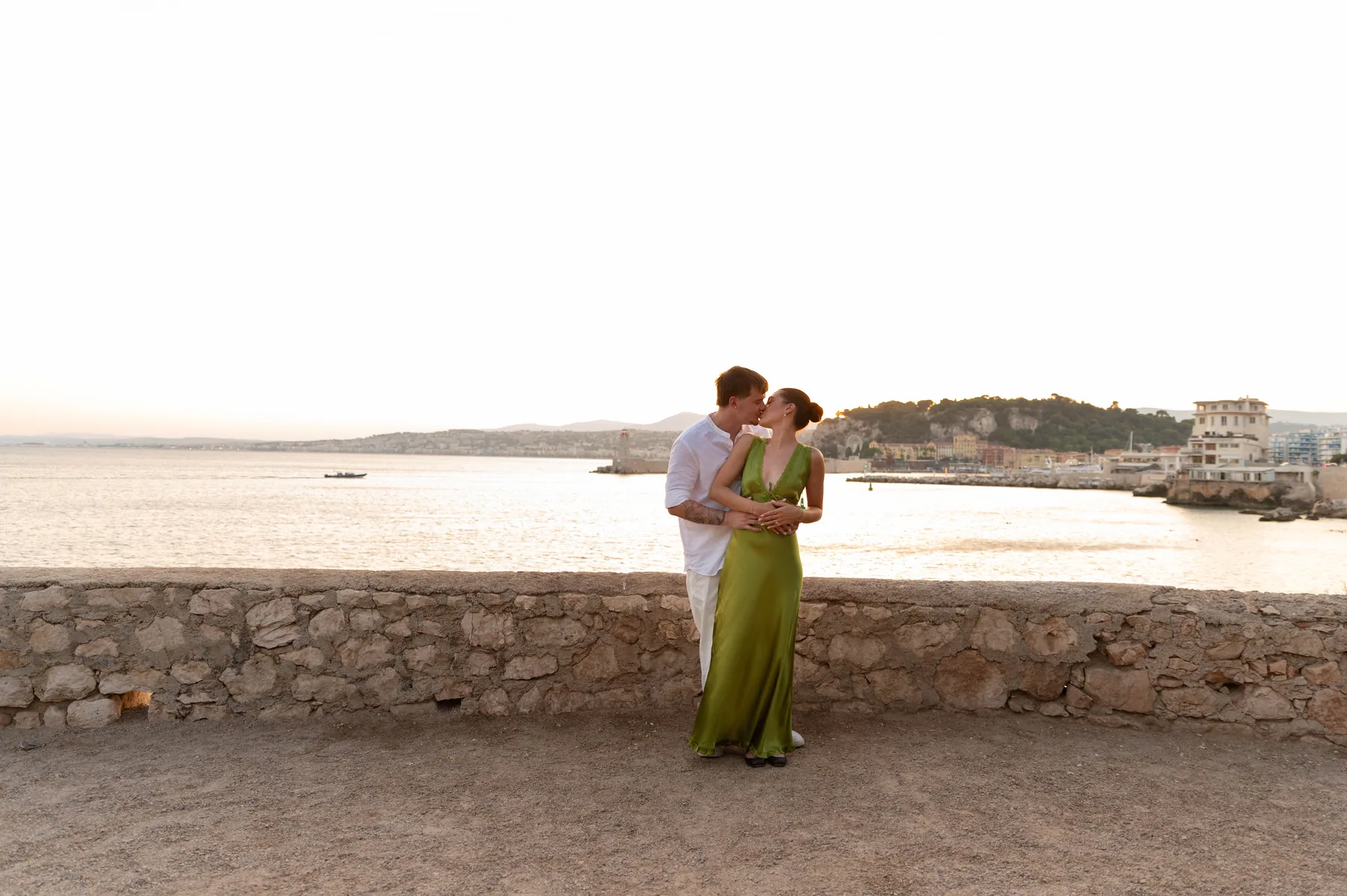 A couple on the rocks at sunset
