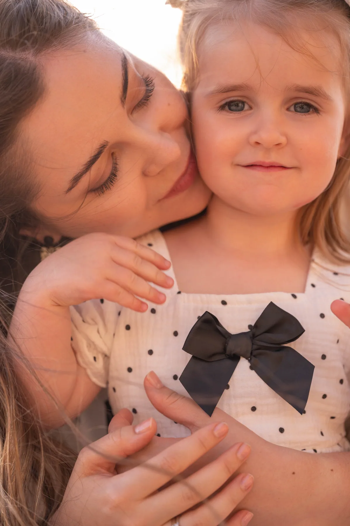 A mother holding her daughter close